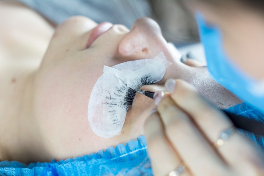 Woman with beautifully done eyelash extensions smiling confidently